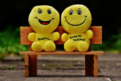 smiley faced people on bench